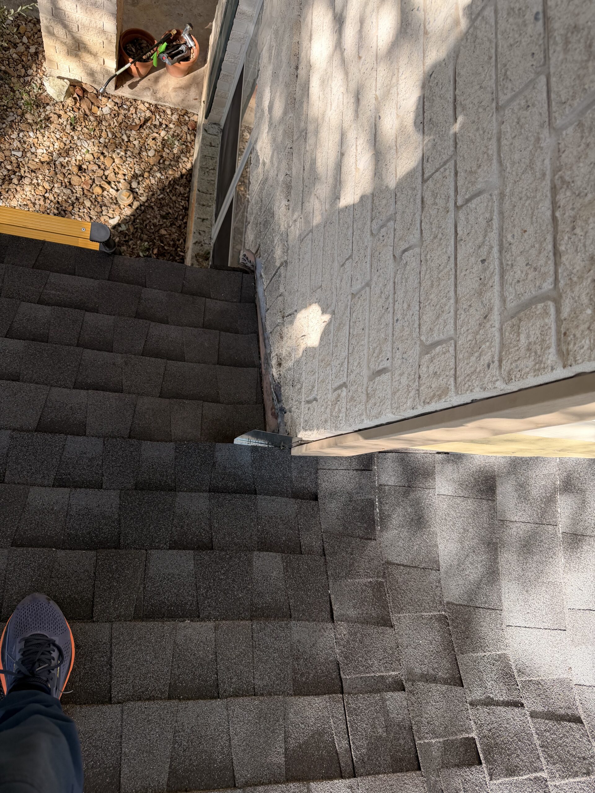 Completed roof-to-wall flashing and shingle repair in San Antonio, TX