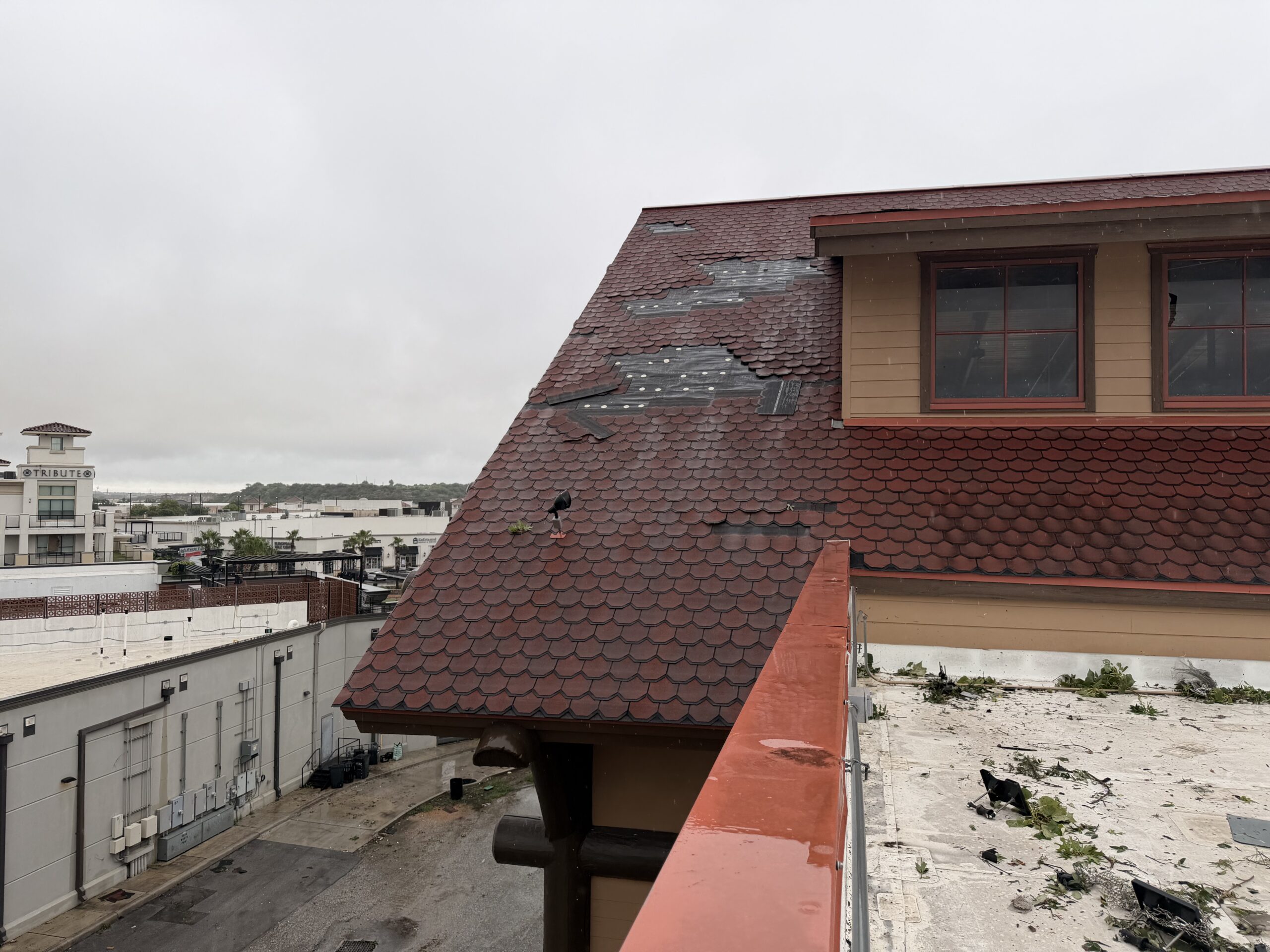 Storm-damaged commercial roof before emergency temporary protection in San Antonio, TX