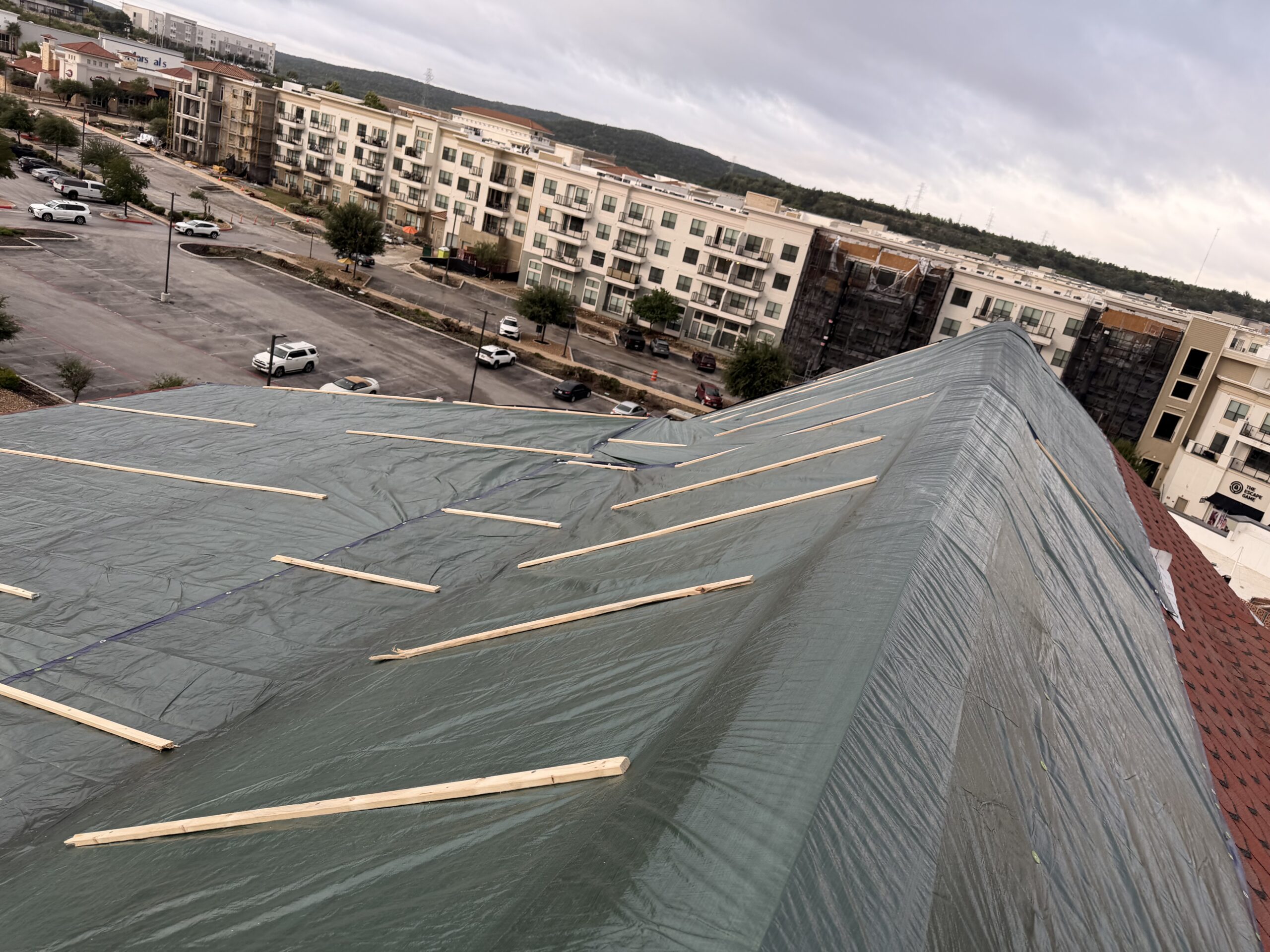 Completed emergency temporary roof tarp protecting a storm-damaged commercial roof in San Antonio, TX