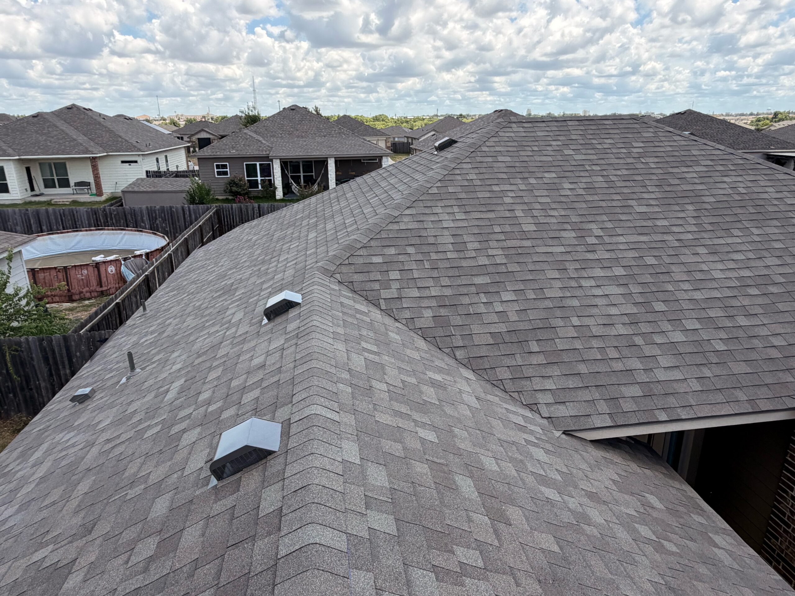 Completed Owens Corning Oakridge Driftwood roof showing valleys, ridges and roof vents
