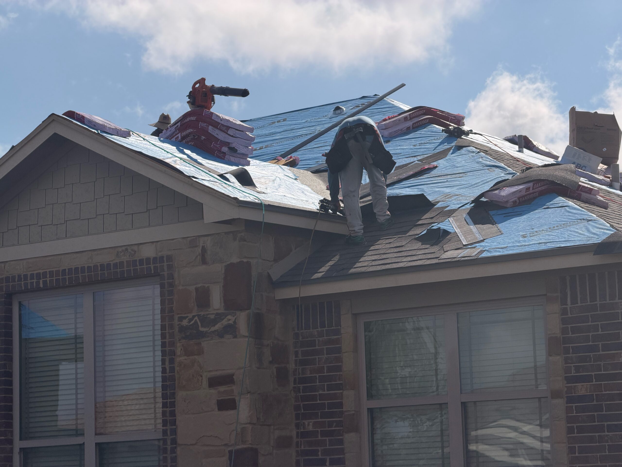 Owens Corning Oakridge shingles being installed during a residential roof replacement in Temple, TX