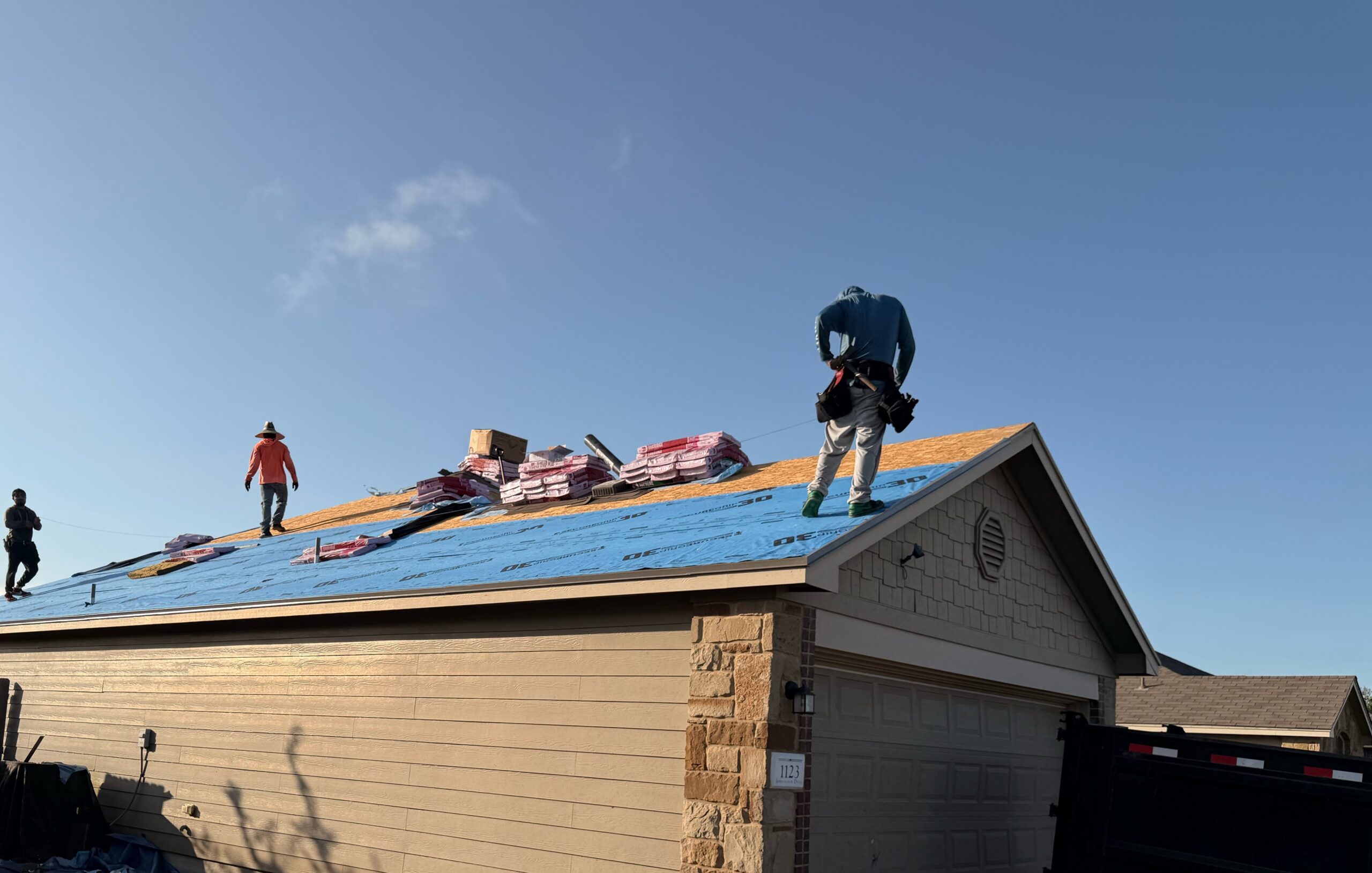 Roofing crew working during a residential roof replacement in Temple, TX